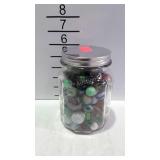 Jar of marbles with some shooters
