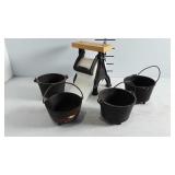 A set of four cast iron cauldrons and a note