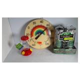 An outdoor thermometer, hummingbird feeder and
