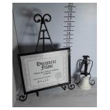 A ceramic bell wall hanging and Easel with an