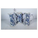 Blue and white pitchers, three