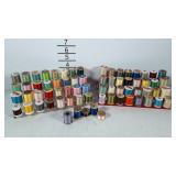 Thread spool stands, full of spools, many are