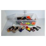 A Collection of toy cars in a plastic box
