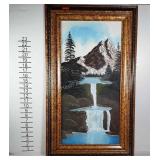 Framed mountain scene painted on canvas signed by