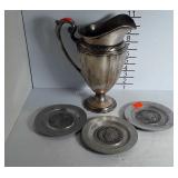 Metalwware Pitcher and three pewter coon plates