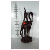 Wooden sculpture of 2 herons eating a fish.  Lots