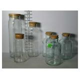 Glass canisters - two sets of 3 each with cork &