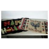 Two doormat size rugs. One "HAPPY HOLIDAYS" and