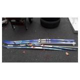 two sets of skis with poles