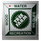 Metal Tree Farm sign. Bright graphics and shows
