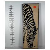 Zebra needlework wall art in frame.