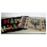 Two doormat size rugs. One "HAPPY HOLIDAYS" and