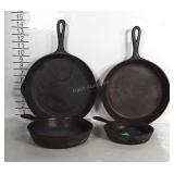 4 cast iron skillets, all in different sizes.