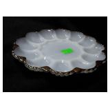 Milk glass egg plate with gold trim.