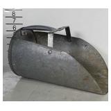 Large metal feed scoop.