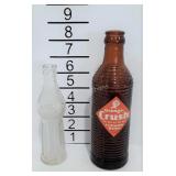 Two soda bottles  smile and Orange Crush soda