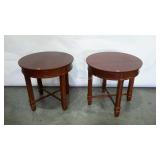 Two round end tables with cross undercarriage,