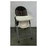 High chair.  Adjustable height and folds for