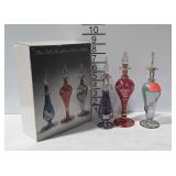 Three tall mouth blown perfume bottles with