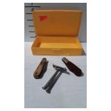 Two pocket knives and older razor in yellow box