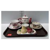 Tray with teapot, saucers, coffee cups, fruit
