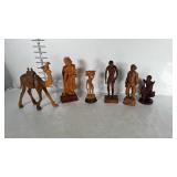 Wooden figurines, men and a camel.