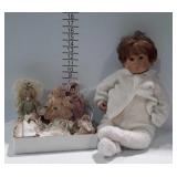 Small porcelain dolls and larger doll by