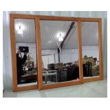 Three matching wood framed wall mirrors, each is