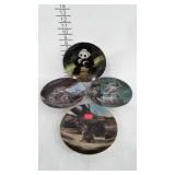 Four wildlife collector plates
