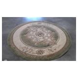 Round rug, raised center design, needs vacuuming,