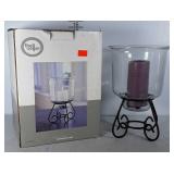 Candle holder with candle on metal stand