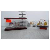 2 tiny ships: one blown glass ship in a display