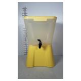 Retro looking yellow poly drink dispenser.  Has