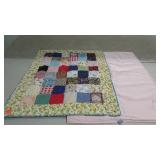 Knotted quilt crib blanket with pink pad, 26 x 34