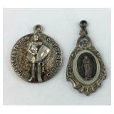 Two Sterling religious charms