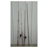 Four older fishing poles, two with reels.