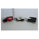 3 cast metal trucks. 2 are banks. Red truck has