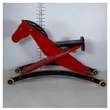 Vintage wooden horse riding toy for toddlers.