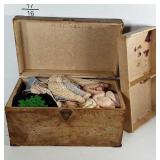 Old box with divided insert, filled with doll