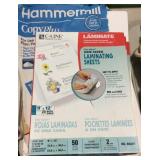 Partial stacks of copy paper and laminate paper