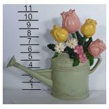 Cast iron watering can door stop.