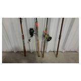 Four older fishing poles, two with reels.
