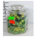 Glass canister / jar full of marbles.