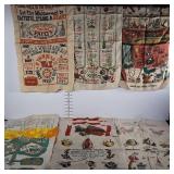 11 kitchen towels. Condition and themes vary.