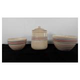 Pottery pieces with pink and blue stripes. The