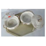 2 older serving dishes with lids. Gold finish in