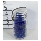 Small jar with blue marbles.