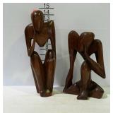 Two wooden carved people figures.