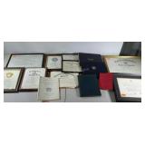 Certificates and diplomas. Some framed.