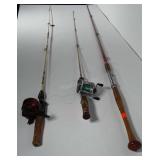 3 older fishing poles. 2 have reels.